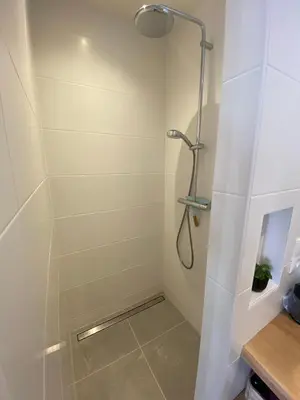 a shower with a glass door in a bathroom at Paauwze in Rijnsburg