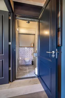 a blue door leading to a bathroom with a toilet at De Heerlijkheid Hensbroek in Hensbroek