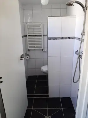 a bathroom with a toilet and a shower stall at Bakker2 in Groet