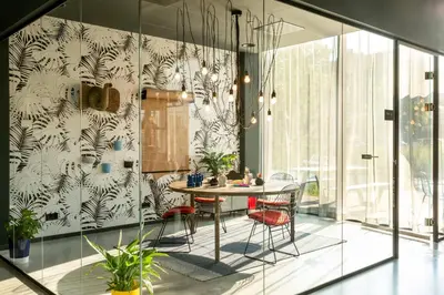 a dining room with a table and chairs at Moxy Utrecht in Utrecht