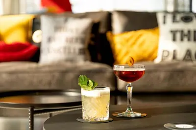 two cocktails on a table in a living room at Moxy Utrecht in Utrecht