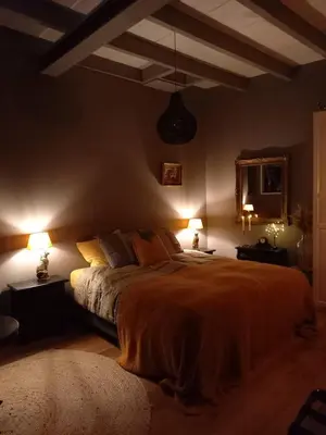 a bedroom with a large bed and two lamps at Vakantiehuis De Oude Bakkerij in Katwijk aan Zee