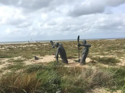three statues of people standing in a field at Vakantiehuis De Oude Bakkerij in Katwijk aan Zee