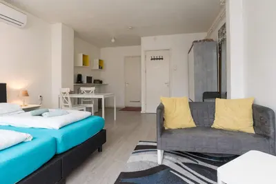 a bedroom with a bed and a couch and a table at RedLight District Private Smokers Friendly Studio in Amsterdam