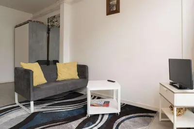 a living room with a couch and a tv at RedLight District Private Smokers Friendly Studio in Amsterdam