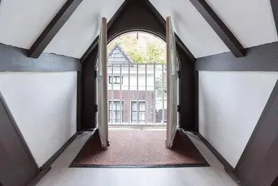an open door into a hallway with a window at RedLight District Smokers Friendly Private Studio in Amsterdam