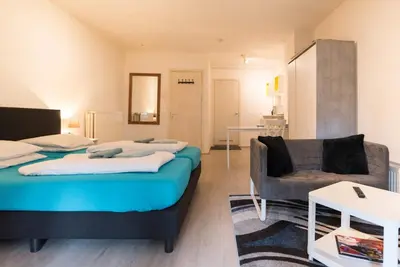 a bedroom with two beds and a couch at RedLight District Smokers Friendly Private Studio in Amsterdam