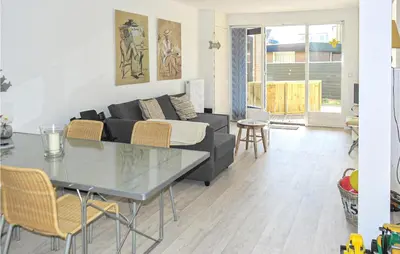 a living room with a couch and a table at Zeekalfje in Bergen aan Zee