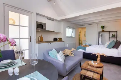 a living room with a couch and a bed at Coast Guesthouse in Zandvoort