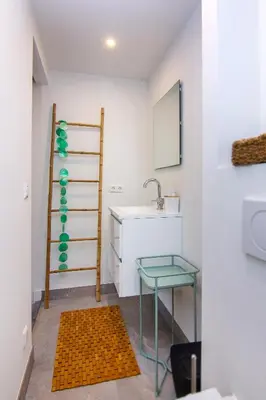 a bathroom with a sink and a glass table at Coast Guesthouse in Zandvoort
