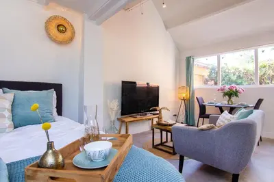 a living room with a bed and a table at Coast Guesthouse in Zandvoort