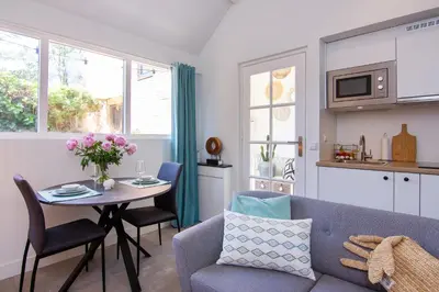 a living room with a blue couch and a table at Coast Guesthouse in Zandvoort