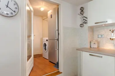 a kitchen with a refrigerator and a washing machine at B&B The Catch Apartment in Amsterdam