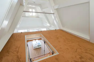 an empty room with a refrigerator in the middle of it at B&B The Catch Apartment in Amsterdam