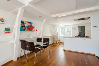a kitchen and dining room with a table and chairs at B&B The Catch Apartment in Amsterdam