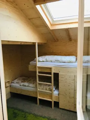 a bunk bed in a wooden cabin with a window at Guest House Amersfoort Center in Amersfoort