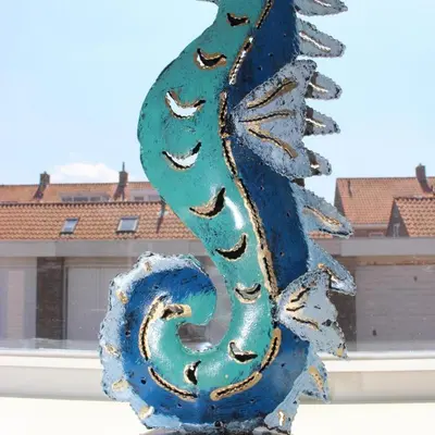 a blue dragon statue in front of a building at Heerlijke vakantiehuisjes in Egmond in Egmond aan Zee