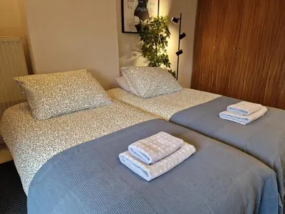 two beds with towels on them in a bedroom at Adam's loft in Amsterdam