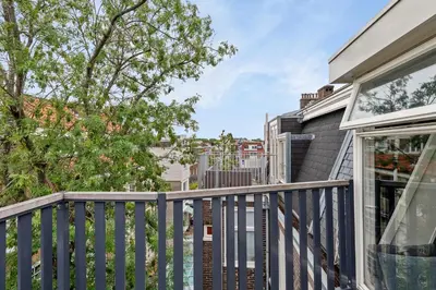 a balcony with a fence and a house at Adam's loft in Amsterdam