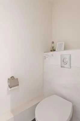 a white bathroom with a white toilet and a sink at Adam's loft in Amsterdam