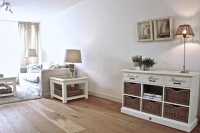 a living room with a couch and a table at Stylish Canalhouse B in Amsterdam