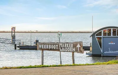 a sign in front of a body of water at Mermaid-Hausboote 2 in Lelystad