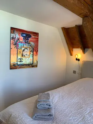 a bedroom with a bed with a picture on the wall at The Harbour Leiden in Leiden