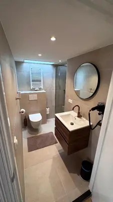 a bathroom with a sink and a toilet and a mirror at The Harbour Leiden in Leiden