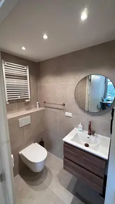 a bathroom with a toilet and a sink and a mirror at The Harbour Leiden in Leiden
