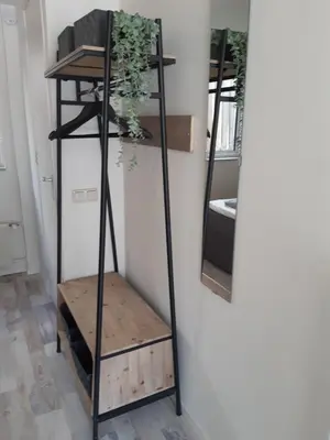 a shelf with a plant on it next to a wall at Sunny Residence in Zandvoort