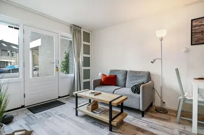 a living room with a couch and a table at Sunny Residence in Zandvoort