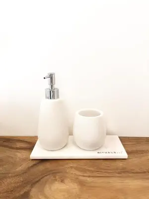 two white cups sitting on a cutting board with a faucet at Beach House For You - Luxe verblijf, 5 min van het strand in Katwijk aan Zee