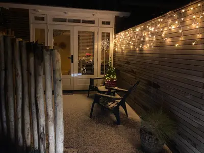 a porch with christmas lights on the side of a house at Beach House For You - Luxe verblijf, 5 min van het strand in Katwijk aan Zee