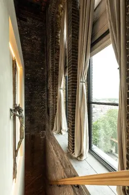 a room with a brick wall and a window at The Clock Tower in Weesp