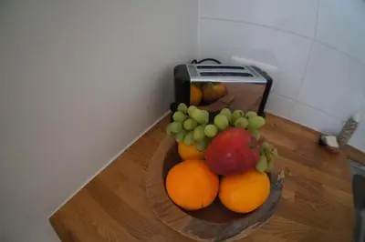 a bowl of fruit on a table next to a toaster at Prince On The Roof in Amsterdam