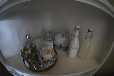 a shelf with two bottles and a basket of items at Prince On The Roof in Amsterdam