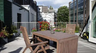 a wooden table and two chairs on a patio at Prince On The Roof in Amsterdam