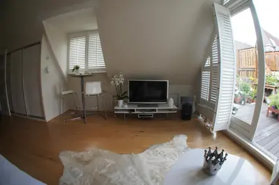 a living room with a television and a table at Prince On The Roof in Amsterdam