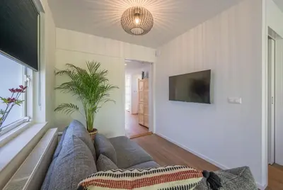 a living room with a couch and a potted plant at 't Kleine eiland in Zuid-Scharwoude