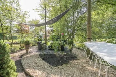 a garden with potted plants and a tent at 't Kleine eiland in Zuid-Scharwoude