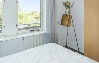 a bedroom with a bed and a window at Awesome Apartment In Bergen An Zee in Bergen aan Zee