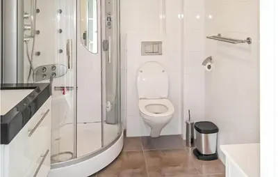 a white bathroom with a toilet and a shower at Awesome Apartment In Bergen An Zee in Bergen aan Zee