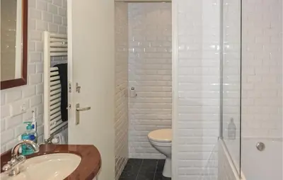 a bathroom with a toilet and a sink and a shower at Zeebalkon in Bergen aan Zee