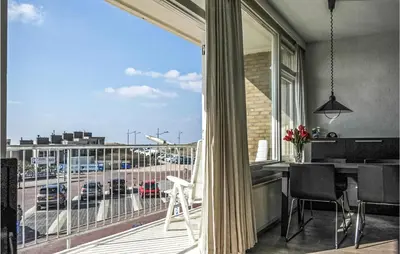 a balcony with a view of a parking lot at Zeebalkon in Bergen aan Zee