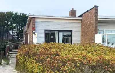 a house with a bush in front of it at Pimpernel1 in Bergen aan Zee