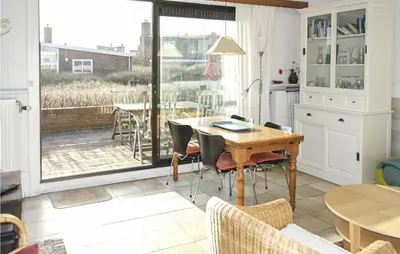 a kitchen with a table and chairs and a patio at Pimpernel1 in Bergen aan Zee