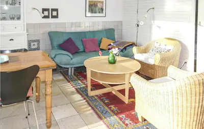 a living room with a couch and chairs and a table at Pimpernel1 in Bergen aan Zee