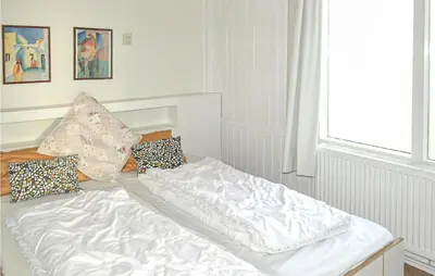 a white bed with pillows on it in a room at Pimpernel1 in Bergen aan Zee