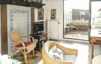 a living room with two chairs and a table at Pimpernel1 in Bergen aan Zee