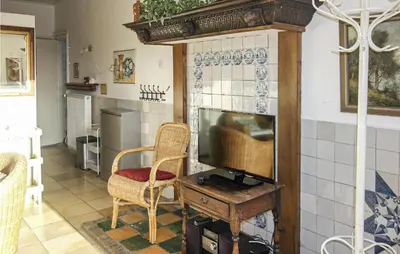 a living room with a television and a chair at Pimpernel1 in Bergen aan Zee
